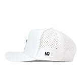 The Creighton Bluejays Basketball Hat in white by No Rivals is shown from the side, highlighting small perforated holes on the back panels and a rectangular NR logo patch near the rear. Crafted with performance fabric for enhanced comfort and durability, this cap features a curved brim, structured front, and classic snapback closure.