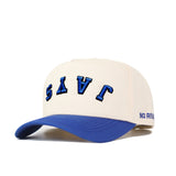 The Upside Down JAYS Hat by No Rivals features cream cotton-canvas, a blue curved brim, "JAYS" embroidered upside down in bold blue, and "NO RIVAL" stitched on the side—Creighton’s classic colors on a snapback style.