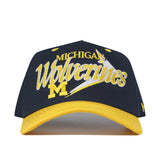 Show your team spirit with the Michigan Wolverines Boomerang Hat by No Rivals—a navy blue and yellow snapback featuring an embroidered M logo on the front, perfect for your gameday outfit.