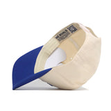 A beige and blue Creighton Logo Patch Hat by No Rivals is shown from the side and underneath, revealing its inside label. Crafted with a cotton blend for comfort.