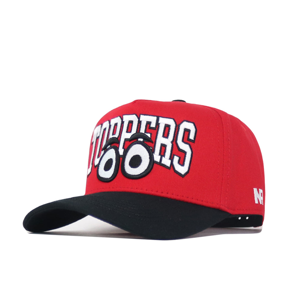 The No Rivals WKU Toppers Big Red Eyes Hat is a red snapback with a black brim, bold white "TOPPERS" text, and cartoon wide eyes embroidered below, offering a structured fit made from premium cotton.