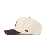 The Oregon Espresso Hat by No Rivals is a cream snapback baseball cap with a brown brim. It features "NR" embroidered in brown thread near the back for a subtle brand logo—ideal for your gameday look.