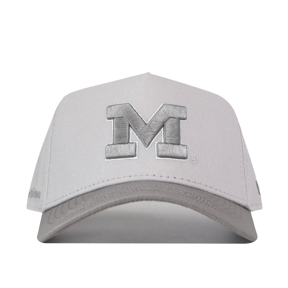 Elevate your gameday style with the Michigan Wolverines Graphite Hat from No Rivals—a light gray cap featuring a large, bold, embroidered letter M on the front panel, displayed against a crisp white background.