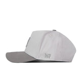 A side view of the Michigan Wolverines Graphite Hat by No Rivals shows its light gray design with a darker gray curved brim. The snap back closure provides a comfortable fit, while the embroidered NR initials near the back on the side add a subtle yet stylish brand detail.