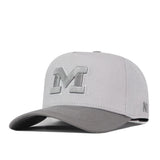 The Michigan Wolverines Graphite Hat by No Rivals features a light gray design with a raised, embroidered “M” on the front and a slightly curved brim. Its snapback closure ensures a comfortable fit, while smaller embroidered letters decorate the side—making it perfect for completing your gameday look.