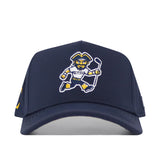 The No Rivals ETSU Golfing Buc Hat in navy features a cartoon mascot embroidered in yellow, white, and blue, holding a hockey stick and wearing an ETSU jersey.