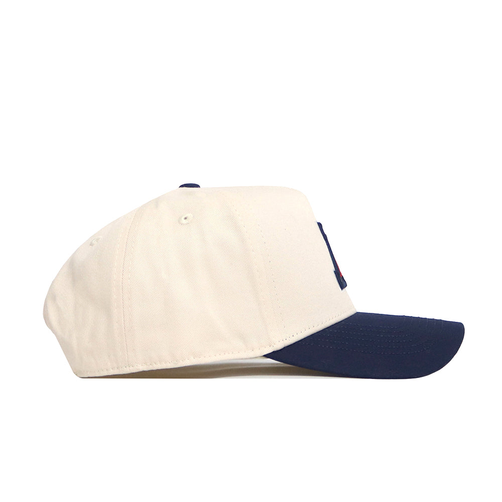 The No Rivals Arizona Logo Patch Hat is a white snapback with a navy blue curved brim, shown side view on a plain background. Features stylish 3D embroidery for added detail.