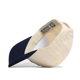 The No Rivals Arizona Logo Patch Hat is shown inside out, revealing interior labels, stitching, a QR code on the inner band, and officially licensed details for authenticity. Cream and navy blue snap back style.