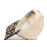 A Michigan Wolverines Camo Connector Hat by No Rivals is turned inside out, revealing an embroidered NO RIVALS logo and a QR code tag on the inner band. The visor showcases a camouflage pattern, highlighting its officially licensed design.