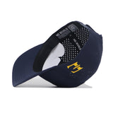 The ETSU Golfing Buc Hat - Navy by No Rivals is a navy perforated performance baseball cap with a yellow side logo, "NO RIVALS" on the inner band, and a snapback closure, shown on a white background.