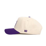 The No Rivals TCU Logo Patch Hat features a white crown, purple brim, and a small purple NR logo patch embroidered on the left side, shown in side profile against a white background.