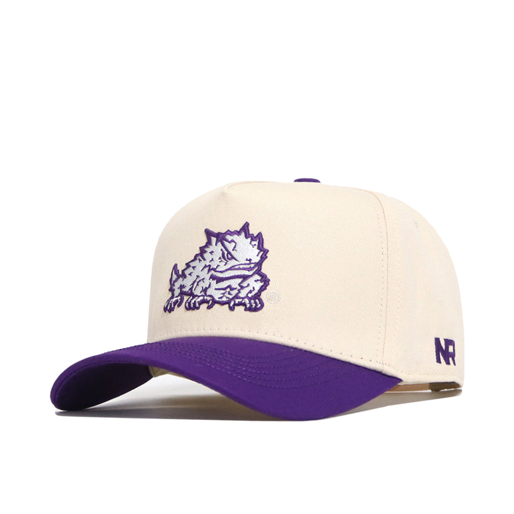 The No Rivals TCU Logo Patch Hat is a cream snapback with a purple brim, featuring a purple horned frog patch on the front and "NR" embroidered on the side.