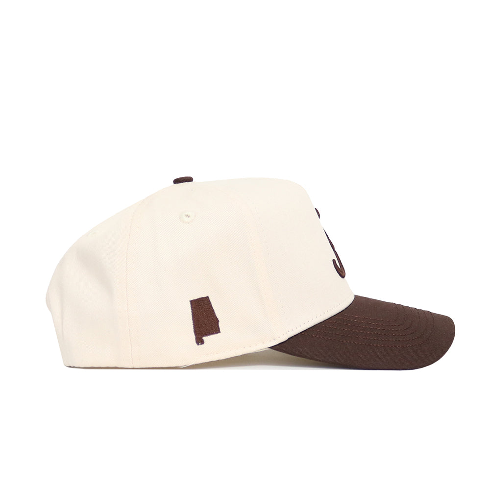 The No Rivals Alabama Espresso Hat features a cream color, structured snapback fit, brown bill, and a small brown Alabama silhouette on the side, all crafted from high-quality cotton.