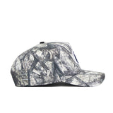 A side view of the No Rivals Penn State Outland Hat, a structured fit cap made from quality cotton in a gray, black, and white camouflage pattern, with a flat brim and a partially visible circular logo on the front.