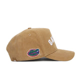 The No Rivals Florida Rustic Hat is a brown cotton canvas snapback with a structured fit, featuring "GATORS" stitched in white on the front and an embroidered alligator logo on the side. The hat is shown from the side against a plain white background.