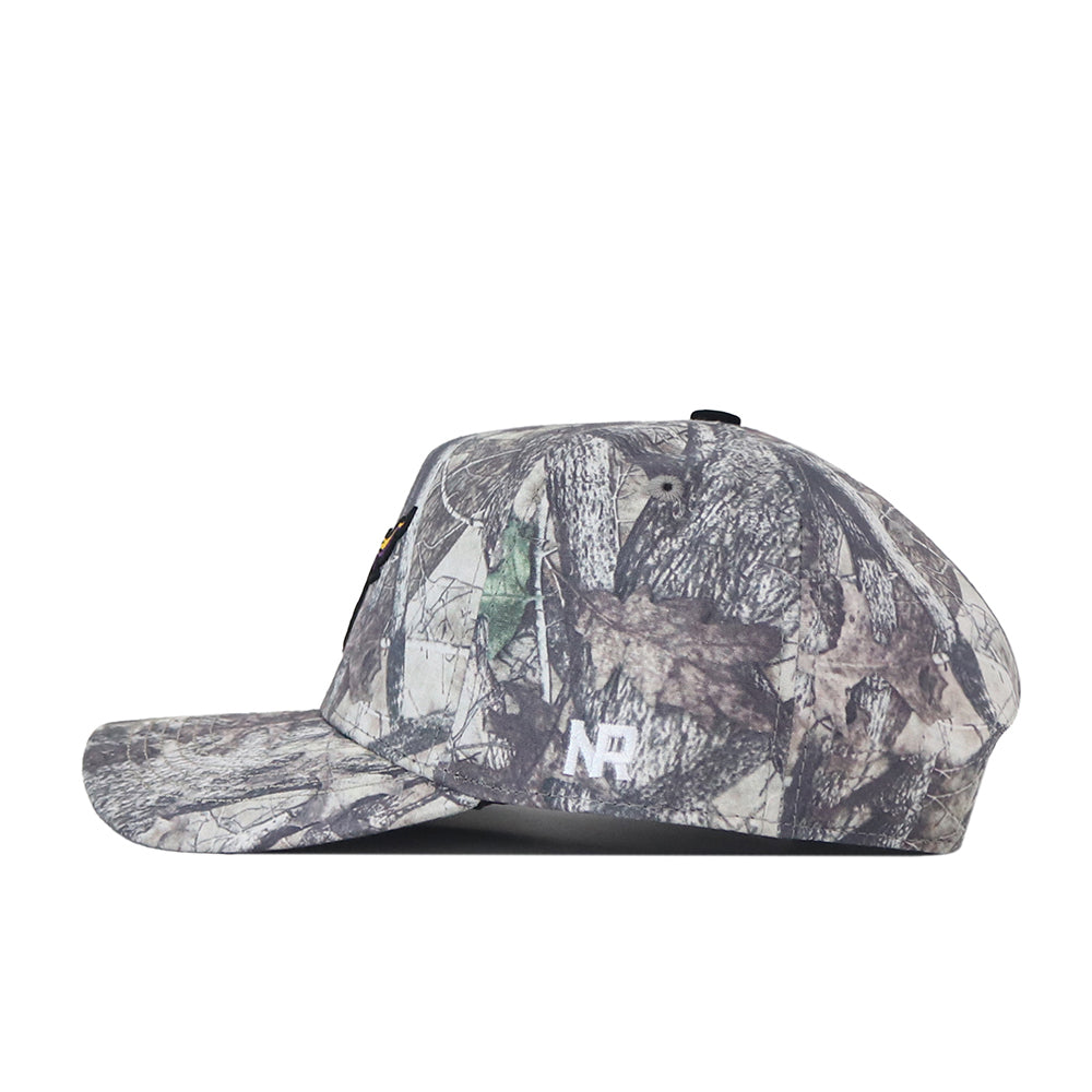 A camouflage flat-brim baseball cap from No Rivals, the Minnesota State University Mankato Outland Hat features a bold white embroidered MSU logo on the side. Shown in a side profile against a plain white background, this snapback is the perfect addition to your gameday fit.