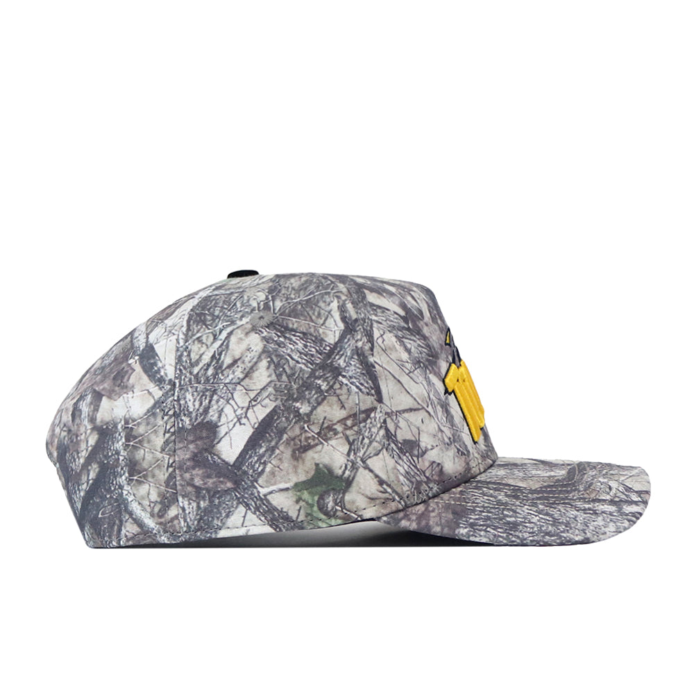 The No Rivals Toledo Outland Hat is displayed in a side view against a white background. This camouflage-patterned baseball cap features a flat brim, structured fit, and embroidered logo, along with a snap back closure for easy adjustment.