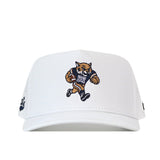 The Montana State Football Hat - White by No Rivals features an embroidered cartoon wildcat mascot holding a football and sporting a jersey with the letter “M” on the front. Designed with a classic Snap Back closure for the perfect Gameday Fit, this white baseball cap is set against a plain background.