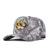 The Mizzou Outland Hat by No Rivals is a structured camo baseball cap featuring an embroidered yellow and black tiger logo on the front. It comes with a curved brim, woodland camouflage pattern, and a snap back adjustment for a customizable fit.