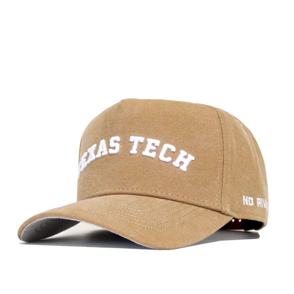 The Texas Tech Rustic Hat by No Rivals is a tan cotton canvas snapback with a structured fit, white TEXAS TECH embroidery on the front, and partially visible NO RIV branding on the side. The hat has a curved brim.