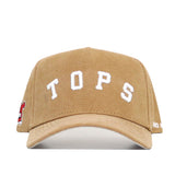 The Western Kentucky Rustic Hat by No Rivals is a tan cotton canvas snapback with "TOPS" in white on the front, a small red and white patch on the left side, and partial white text on the right.