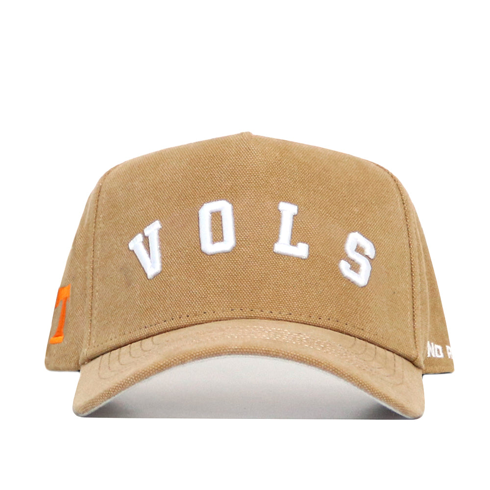 The No Rivals Tennessee Rustic Hat is a tan cotton canvas baseball cap featuring "VOLS" in white on front, an orange square logo on the left, partial white text on the right brim, and a structured fit for durability.