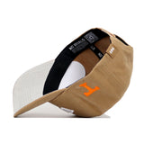 The Tennessee Rustic Hat by No Rivals features a tan, structured fit. Seen from below, it reveals a black NO RIVALS inner band, orange stitched H on the side, white lining, and a grey brim.