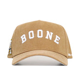 The No Rivals App State Rustic Hat is a tan cotton canvas baseball cap with "BOONE" embroidered in large white letters on the front, extra embroidery on the left side, and an adjustable snap back for a comfortable fit.