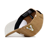 The App State Rustic Hat by No Rivals is a tan and beige cotton canvas baseball cap with a curved brim, an 'A' patch on the side, "NO RIVALS" text on the inner band, and is shown partially flipped to reveal the inside.