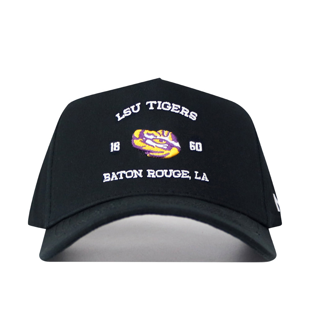 Introducing the LSU Outlaw Hat - Black by No Rivals: This black baseball cap features “LSU TIGERS 1860 BATON ROUGE, LA” embroidered in white, along with a striking tiger’s eye logo in yellow and purple on the front. Designed with a snapback closure, it’s perfect for a comfortable gameday fit.