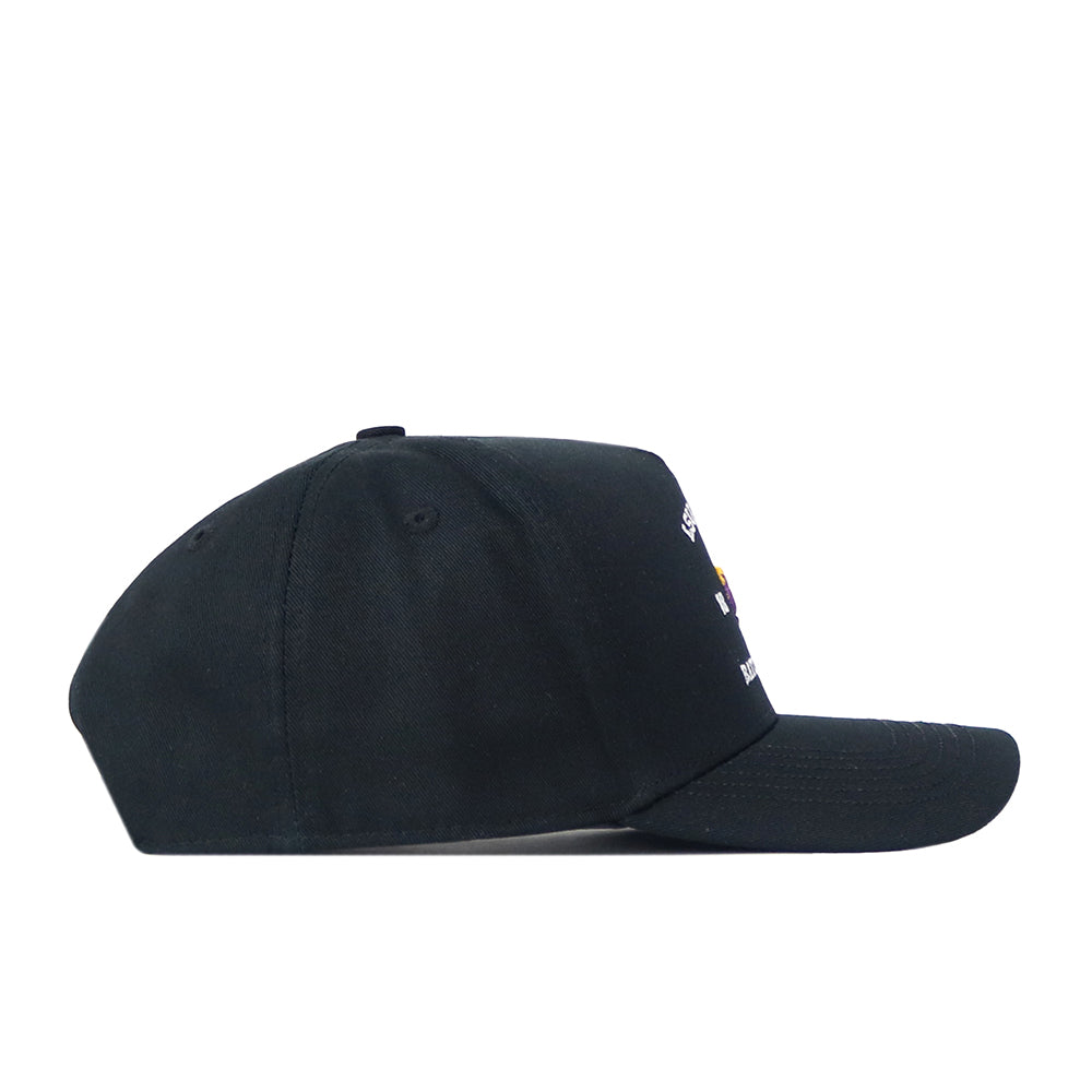 The No Rivals LSU Outlaw Hat in black is displayed from the side against a white background. Partial views of colorful details and an embroidered logo can be seen on the front. Its snapback style enhances the classic gameday look.
