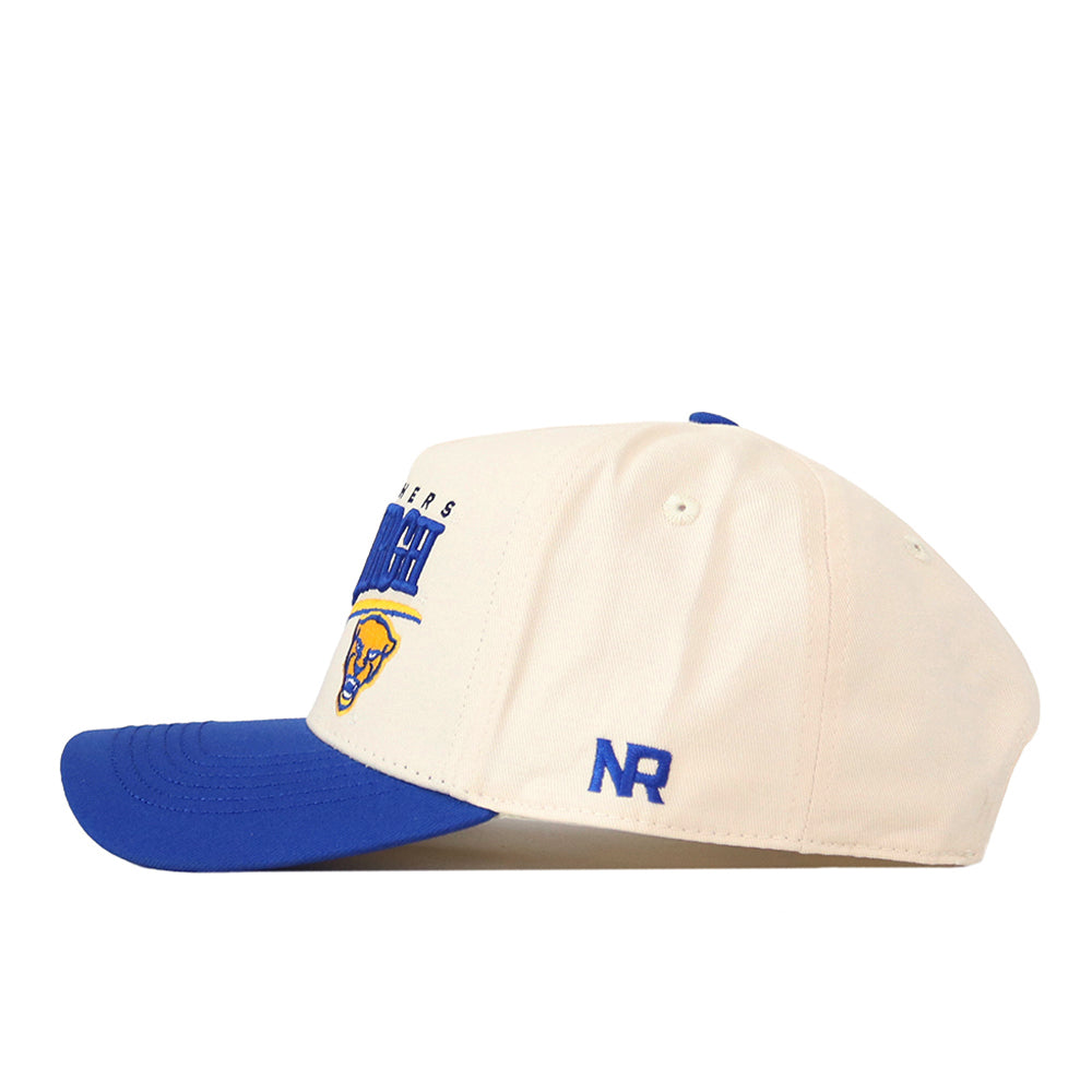 Introducing the Pittsburgh Panthers Stride Hat by No Rivals—a cream-colored baseball cap with a blue brim, showcasing an embroidered logo on the side and “NR” stitched in blue on the left panel. This structured-fit snapback is crafted from high-quality cotton for lasting comfort and style.