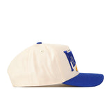 The Pittsburgh Panthers Stride Hat by No Rivals is a cream-colored baseball cap with a blue brim, seen from the side and featuring raised blue and yellow embroidered text on the front panel. Crafted from high-quality cotton, this snapback hat delivers a structured fit for lasting comfort and style.