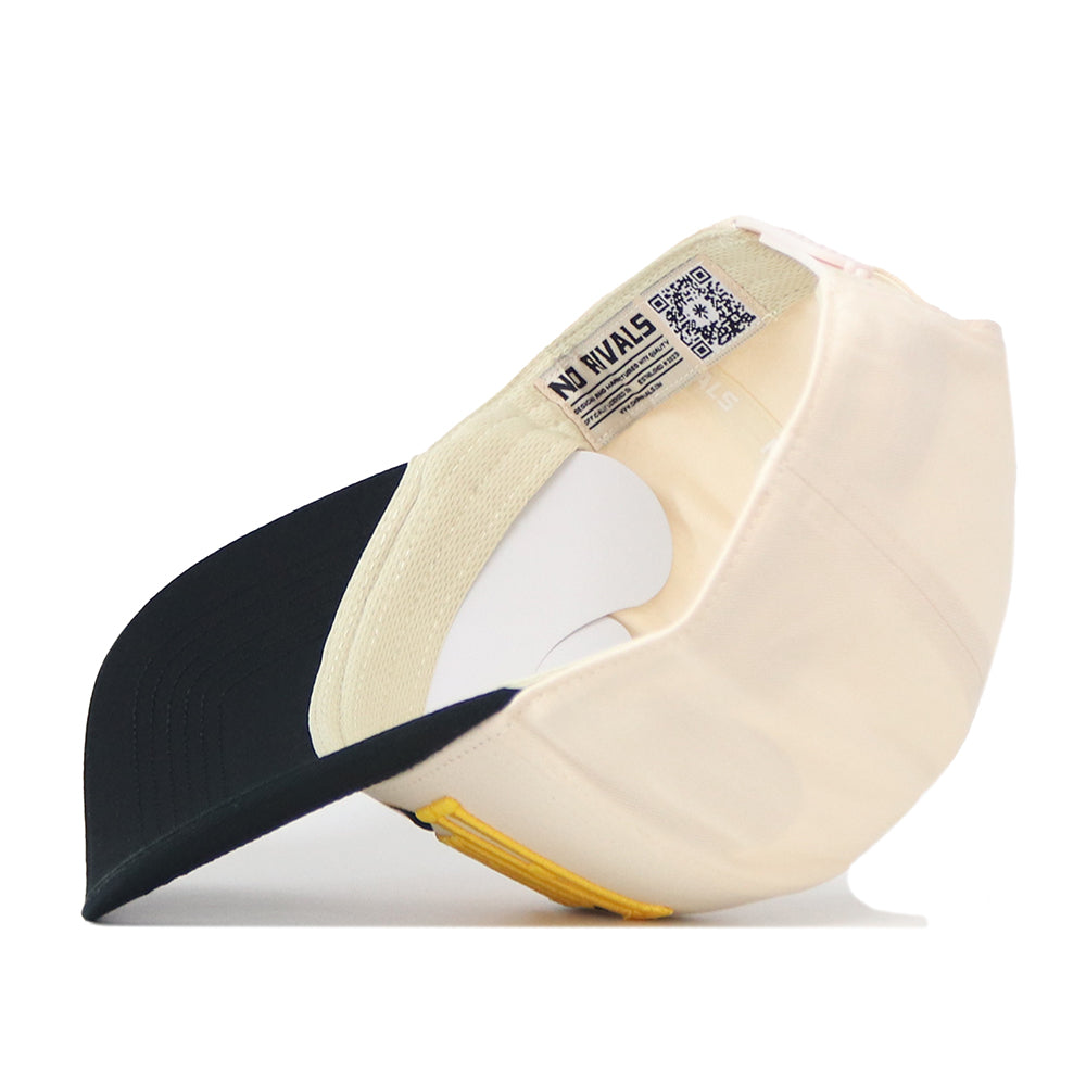 An Iowa Hawkeyes Stride Hat by No Rivals lies upside down, revealing the inside label, QR code, and part of the brim. Made from high-quality cotton with a structured fit, this beige and black snapback baseball cap offers both comfort and durability in style.
