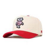 Introducing the Wisconsin Patch Hat by No Rivals—a beige snapback with a striking red brim, showcasing officially licensed, embroidered logos, including a cartoon badger in a red “W” sweater.