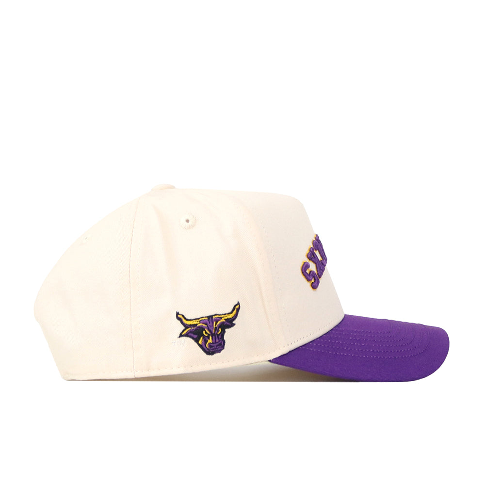 A cream-colored “Upside Down Mavericks Hat - Classic” snapback by No Rivals, featuring a purple brim, a small embroidered Minnesota State Mavericks bulls head logo on the side, and partially visible purple text on the front.
