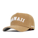 The Hawaii Rustic Hat by No Rivals is a tan cotton canvas snapback featuring "HAWAII" in large white letters on the front and "NO RIV." in smaller white letters on the side of the brim.