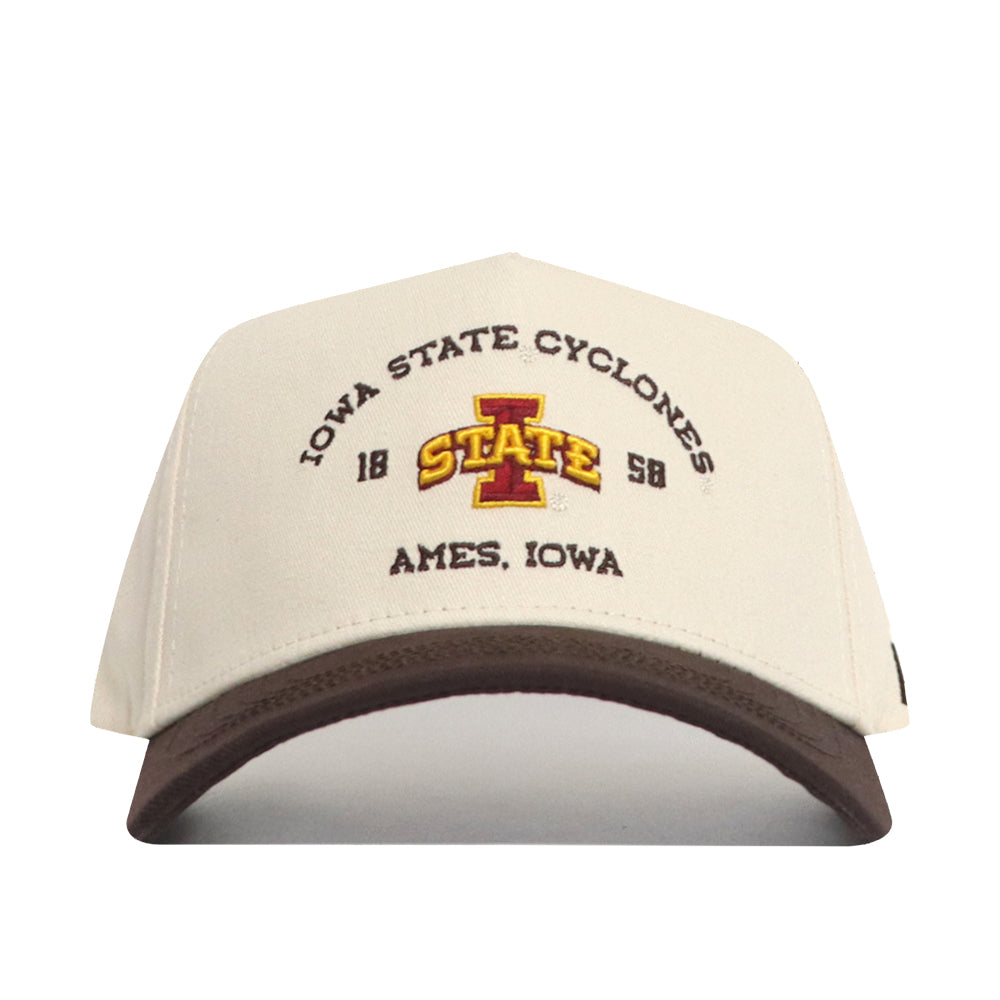 The No Rivals Iowa State Outlaw Hat - Classic is a beige and brown snapback cap with “IOWA STATE CYCLONES, 1888, AMES, IOWA” text and a large officially licensed embroidered I STATE logo on the front.