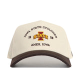 The No Rivals Iowa State Outlaw Hat - Classic is a beige and brown snapback cap with “IOWA STATE CYCLONES, 1888, AMES, IOWA” text and a large officially licensed embroidered I STATE logo on the front.