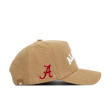 The Alabama Rustic Hat by No Rivals is a tan cotton canvas baseball cap with white ALABAMA text on the front and a red embroidered A logo on the side, featuring a structured fit and shown in a side view.