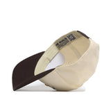 The Iowa State Outlaw Hat - Classic by No Rivals is shown upside down, revealing its interior with a dark brown brim, fabric adjustment strap, officially licensed label with text and QR code, and an embroidered logo for style.