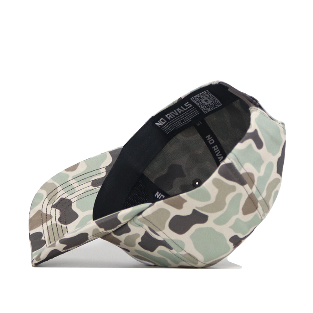 The No Rivals SMU Huntsman Hat is shown angled on its side, featuring a green, beige, and brown camo print in a classic 5-panel design with a black interior band labeled NO RIVALS.