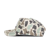 A side view of the No Rivals Texas A&M Huntsman Hat shows its 5-panel green, beige, and brown camo pattern. "NR" is embroidered in dark brown above the brim on the side. It features a classic snapback for adjustable fit.