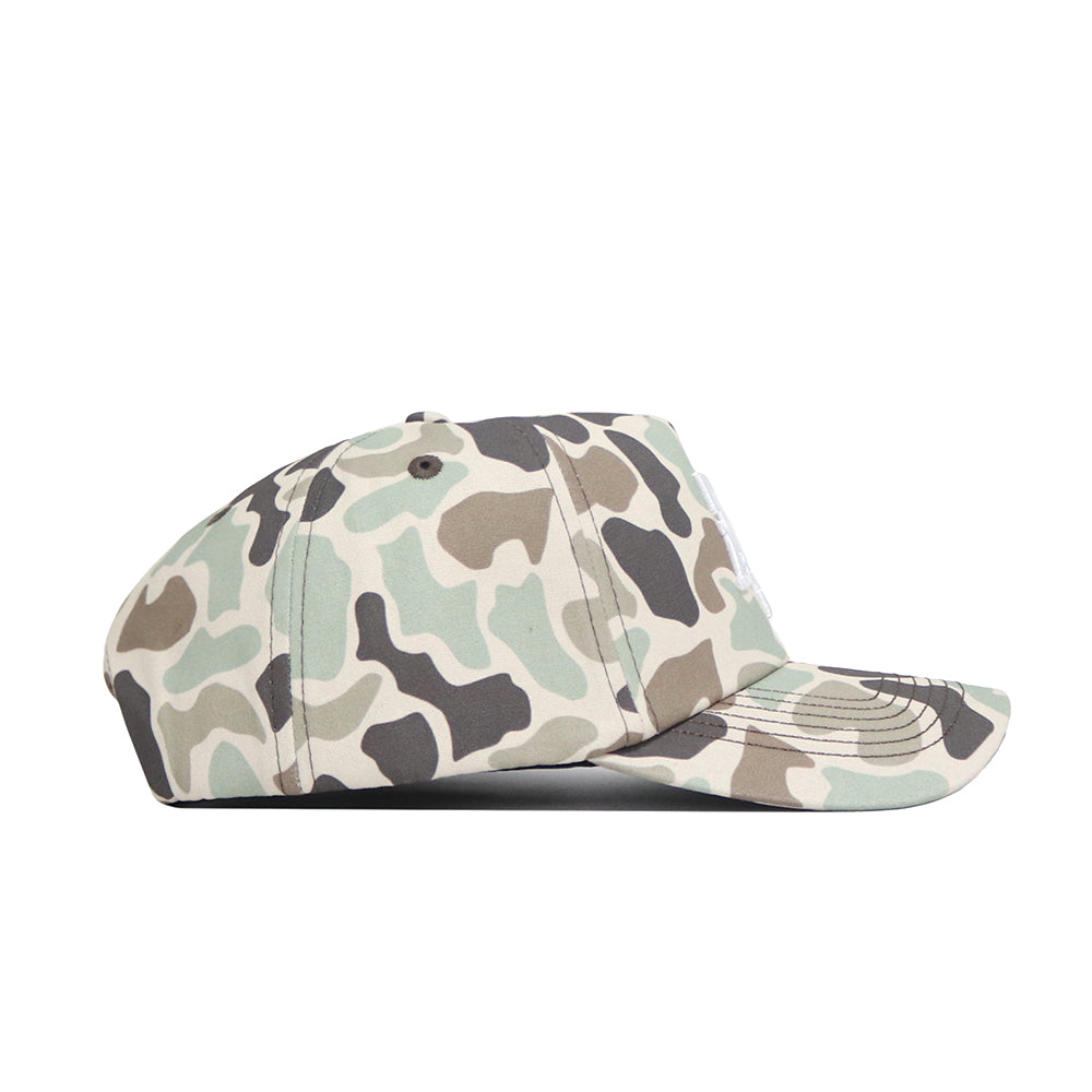 A side view of the Texas A&M Huntsman Hat by No Rivals, a 5-panel cap featuring green, brown, beige, and black duck camo pattern, displayed against a plain white background.