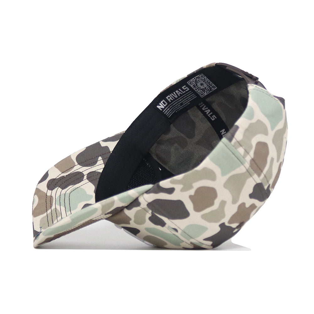 A side view of the Nevada Huntsman Hat by No Rivals, a 5-panel camo baseball cap in green, brown, and beige with an inner sweatband, adjustable snapback strap, and "NO RIVALS" printed inside.