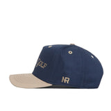 The No Rivals Sunday Golf Hat - Navy and Tan features a navy blue crown, tan brim, beige GOLF embroidery on the front, and an NR logo on the side—ideal for your gameday look.