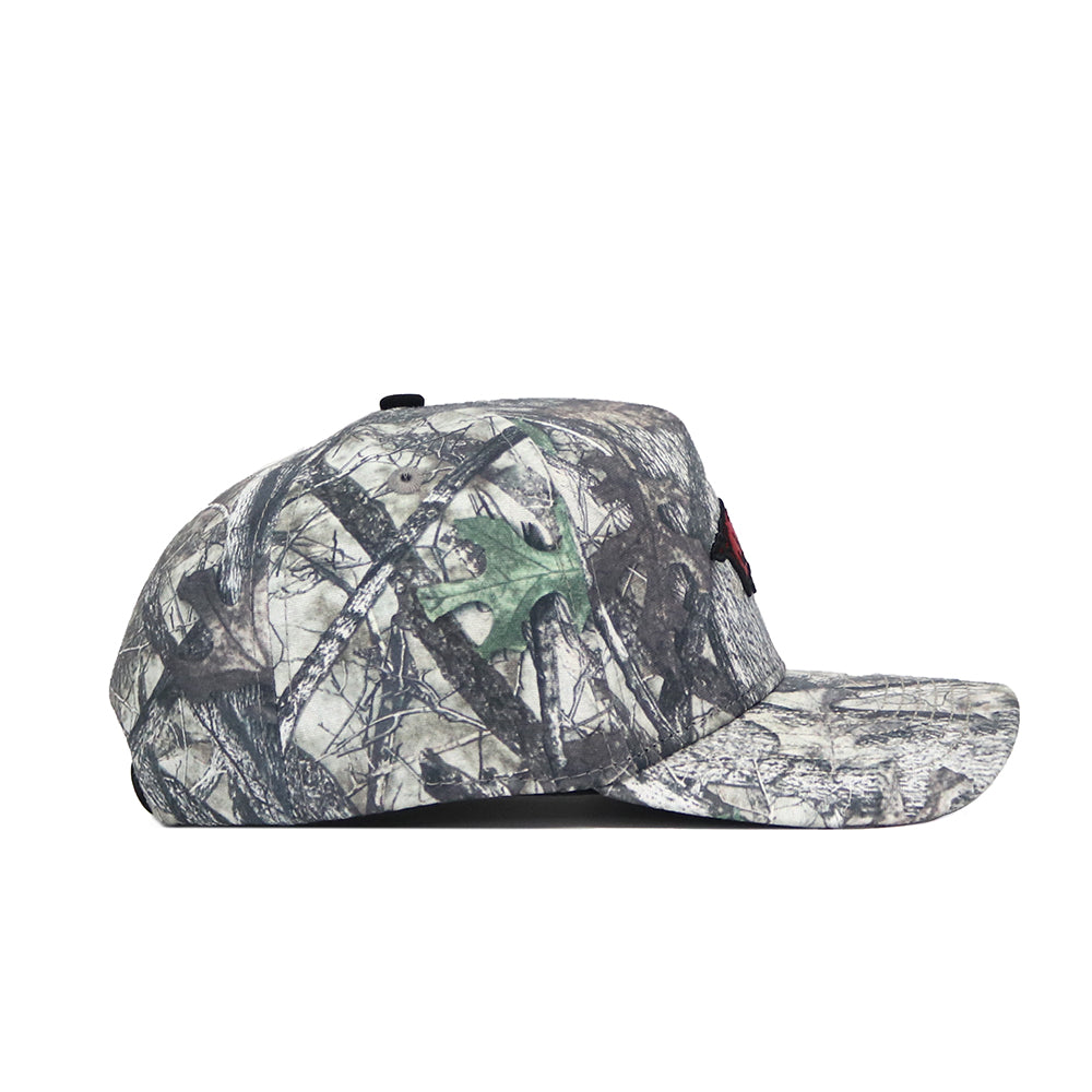 The No Rivals Arkansas Outland Hat is a structured fit snapback baseball cap with a green, brown, and gray camo pattern, flat bill, and high quality cotton construction. Shown in side view against a plain white background.