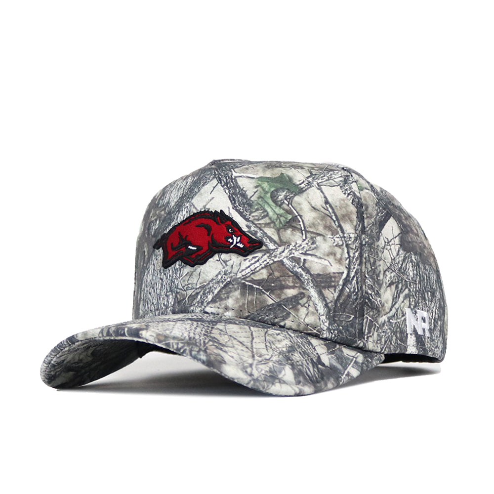The No Rivals Arkansas Outland Hat is a structured cotton snapback with a green, brown, and gray woodland camo pattern, featuring a red razorback hog logo on the front and a white N logo on the left side.