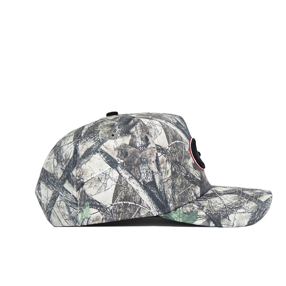 The No Rivals Georgia Outland Hat features a structured fit and a green, brown, and tan camouflage cotton design, shown from the side against a white background.