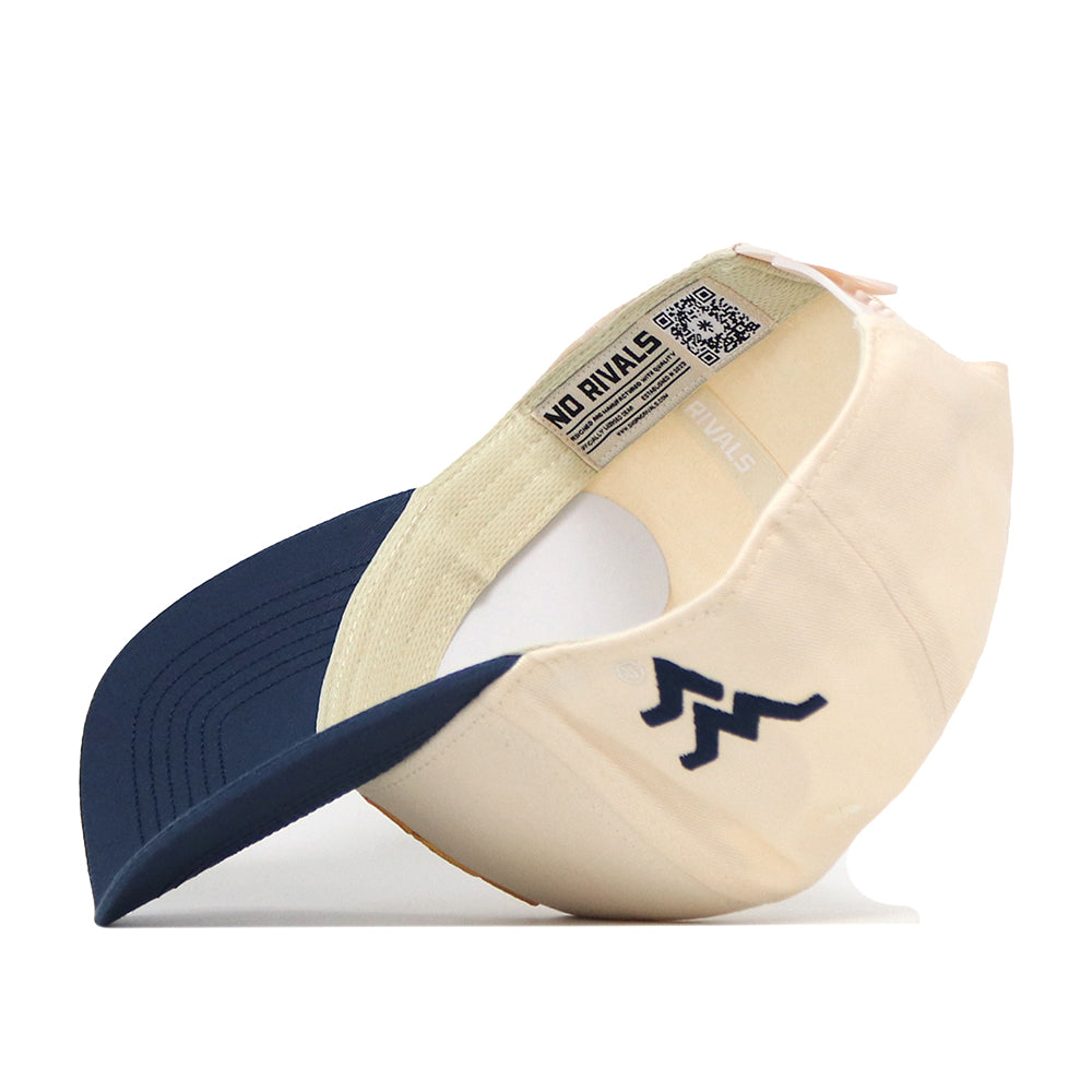 The No Rivals WVU Pat White’s No. 5 Hat in Classic Navy is shown upside down to reveal its interior label and stitching, featuring an embroidered W logo on the side of the brim and a snap back adjustment for a customizable fit.